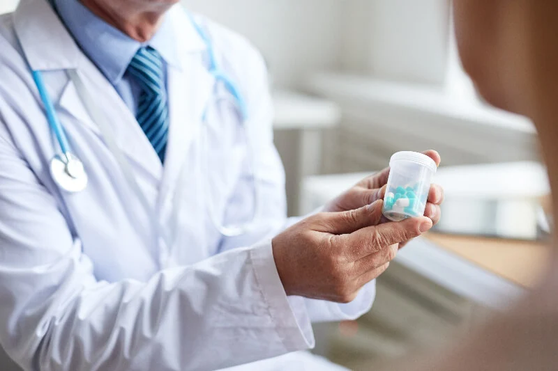 A pain management doctor explains medication management to a patient in North Dallas