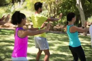 Group practicing gentle outdoor exercise to support chronic pain management