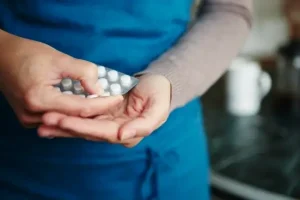 Person holding a blister pack of medication for responsible medication management