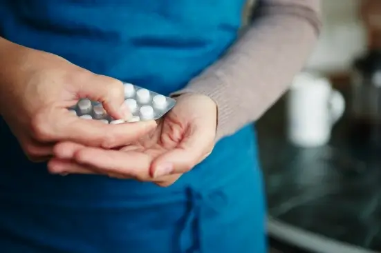 Person holding a blister pack of medication for responsible medication management