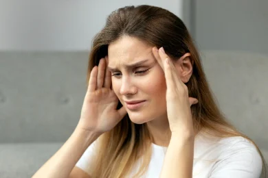 A woman suffers with a headache in North Dallas, Texas