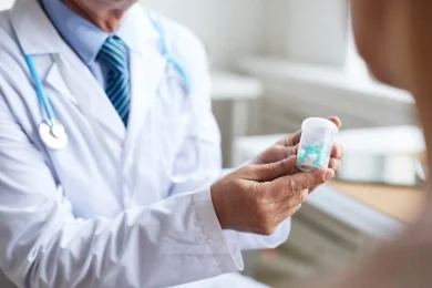 A pain management doctor explains medication management to a patient in North Dallas