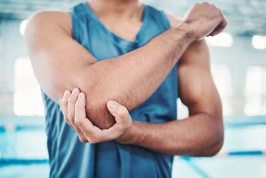 A man with elbow pain in need of pain management in North Dallas
